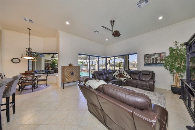 living room featuring ornamental molding, visible vents, and ceiling fan