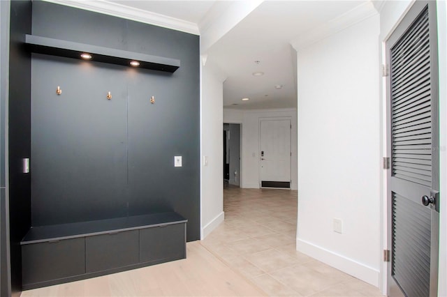 mudroom with light tile patterned floors and ornamental molding