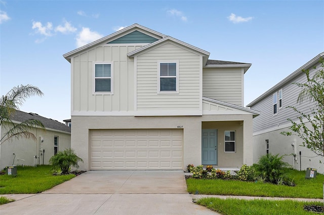 front facade with a garage and a front lawn