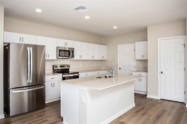 kitchen featuring white cabinets, sink, stainless steel appliances, and a kitchen island with sink