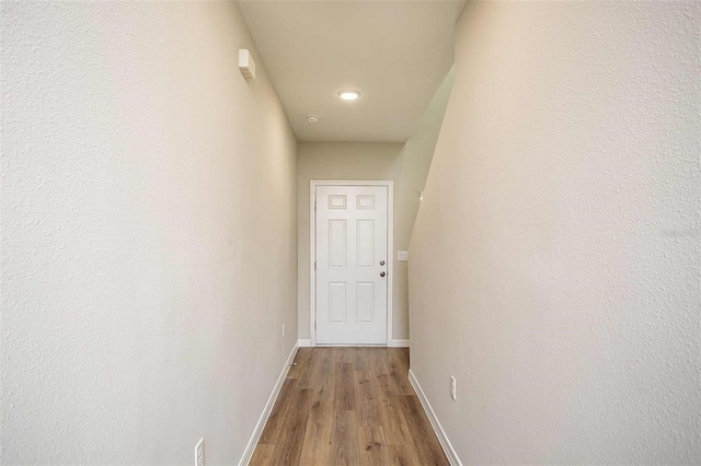 corridor with light hardwood / wood-style flooring