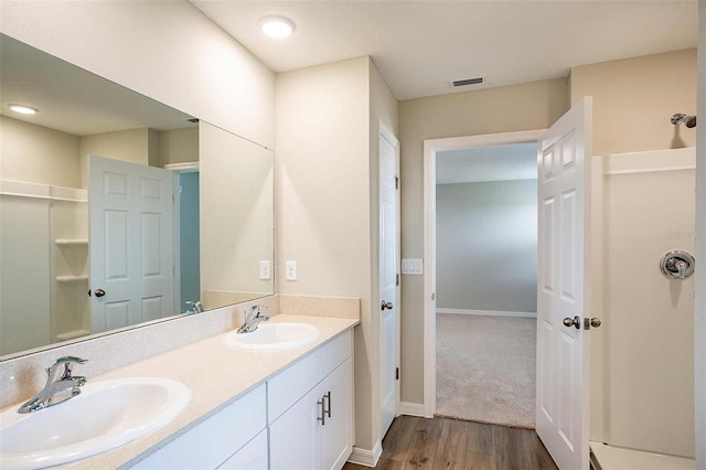 bathroom with vanity and hardwood / wood-style flooring