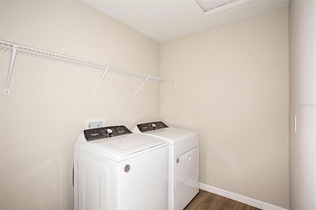 laundry area featuring washer and clothes dryer and dark wood-type flooring