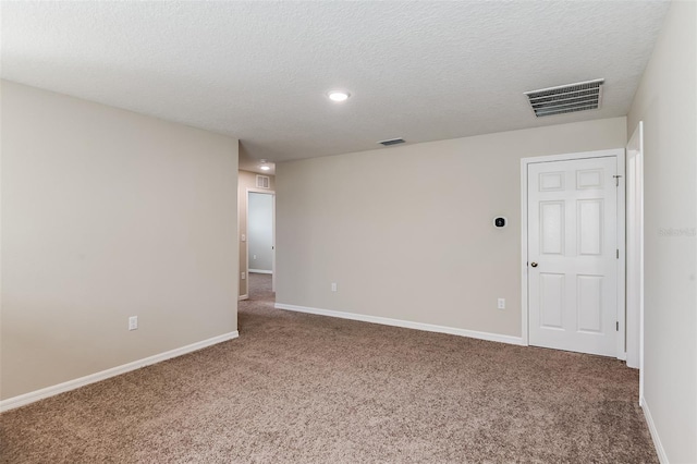 spare room featuring a textured ceiling and carpet floors