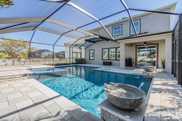 view of swimming pool featuring an in ground hot tub, a patio, ceiling fan, and a lanai