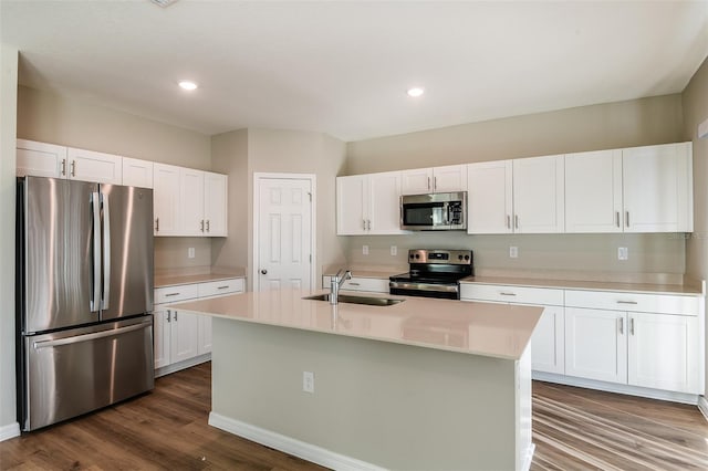 kitchen featuring stainless steel appliances, a kitchen island with sink, sink, dark hardwood / wood-style floors, and white cabinetry