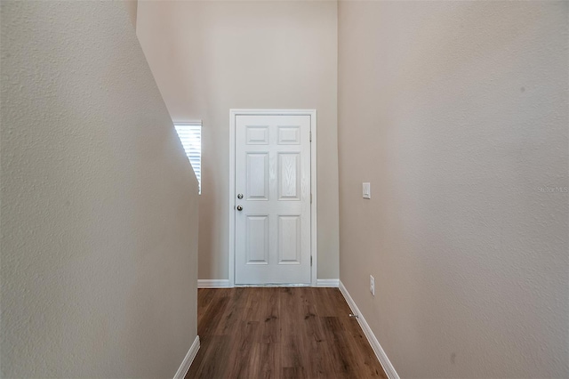 hallway with dark hardwood / wood-style floors