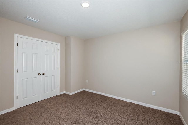 unfurnished bedroom featuring a closet and carpet floors