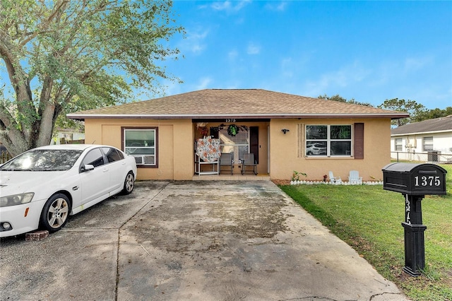 1375 6 Iron Dr, Lakeland, FL 33801 - view of front of home with stucco siding, a front yard, and roof with shingles