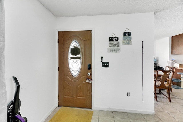 1375 6 Iron Dr, Lakeland, FL 33801 - foyer entrance featuring light tile patterned floors, baseboards, and a textured ceiling