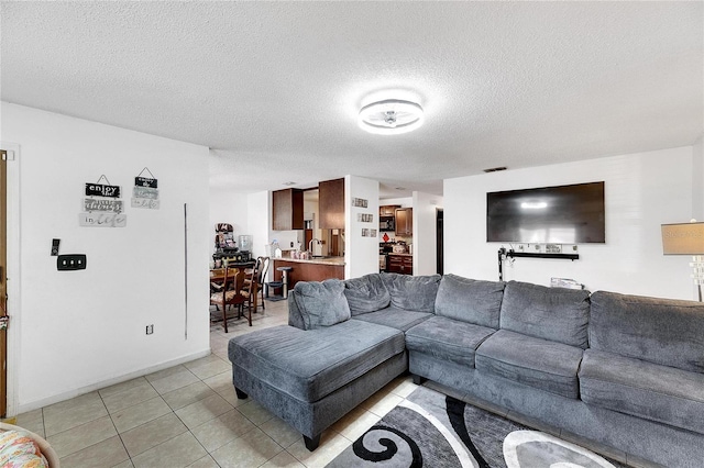 living room with light tile patterned floors and a textured ceiling