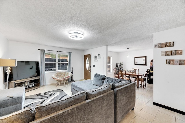 tiled living room featuring a textured ceiling