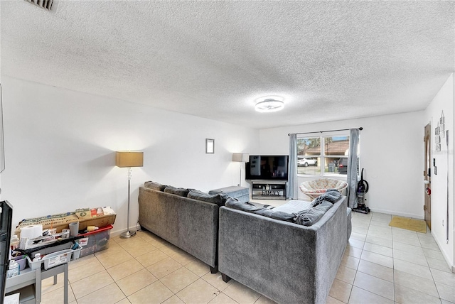 living room featuring light tile patterned floors and a textured ceiling