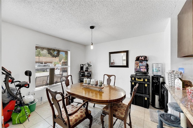 tiled dining room with a textured ceiling