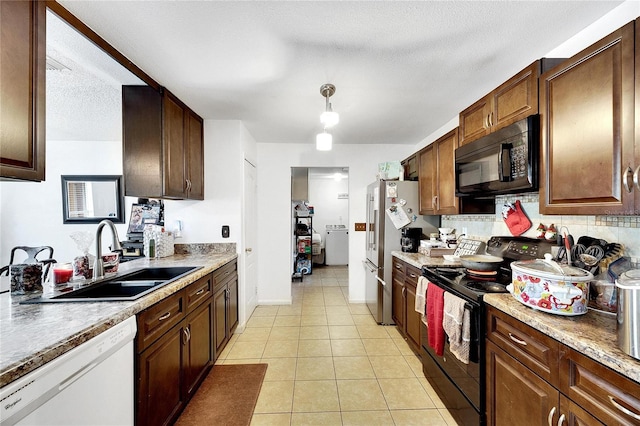 kitchen with a textured ceiling, sink, black appliances, light tile patterned floors, and pendant lighting