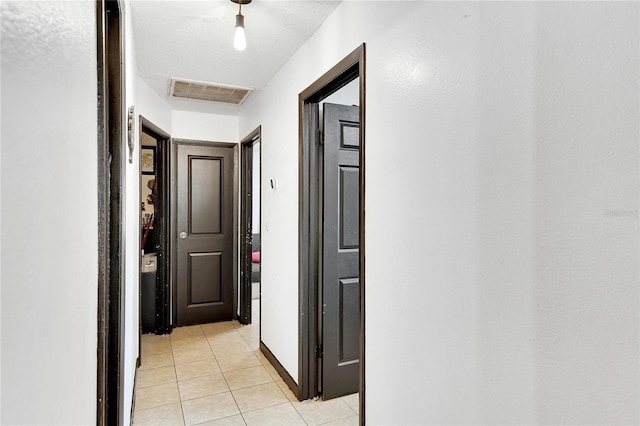 hall featuring light tile patterned floors