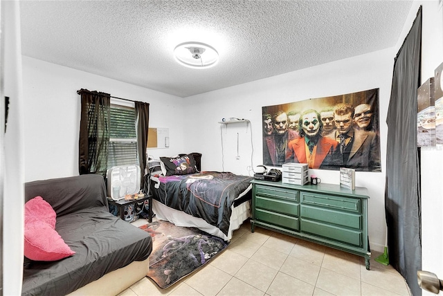 bedroom featuring light tile patterned floors and a textured ceiling