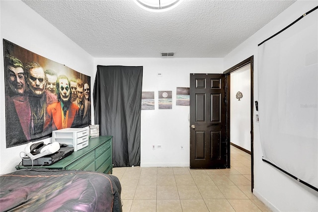 tiled bedroom featuring a textured ceiling