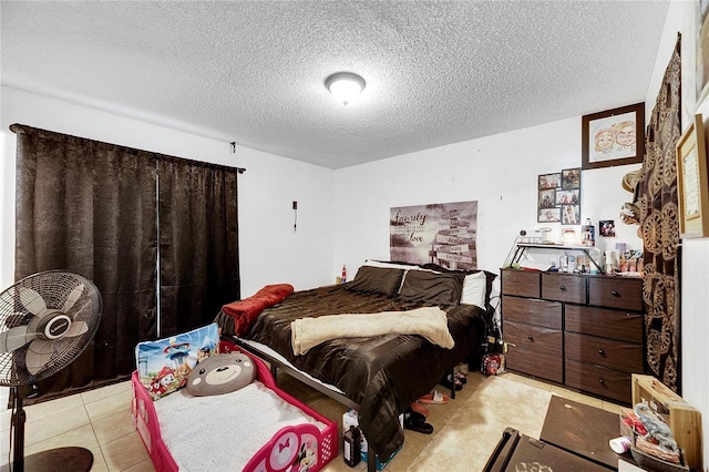 tiled bedroom with a textured ceiling