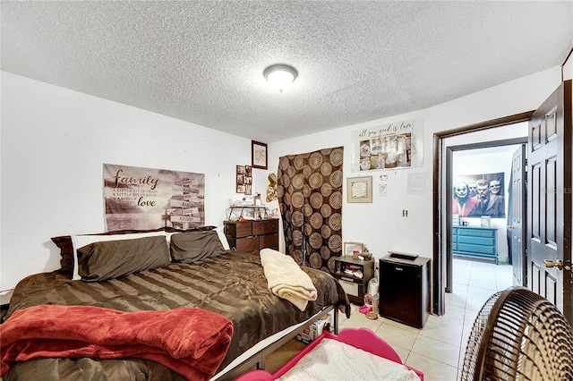 tiled bedroom featuring a textured ceiling