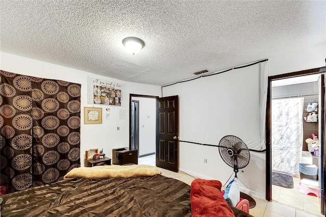 tiled bedroom with a textured ceiling