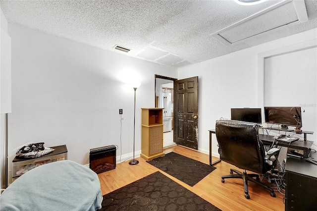 1375 6 Iron Dr, Lakeland, FL 33801 - office area with wood finished floors, a textured ceiling, attic access, and baseboards