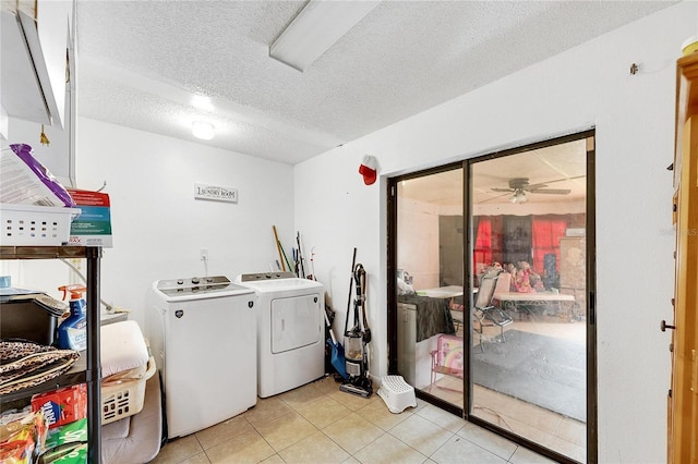 clothes washing area featuring ceiling fan, separate washer and dryer, a textured ceiling, and light tile patterned floors