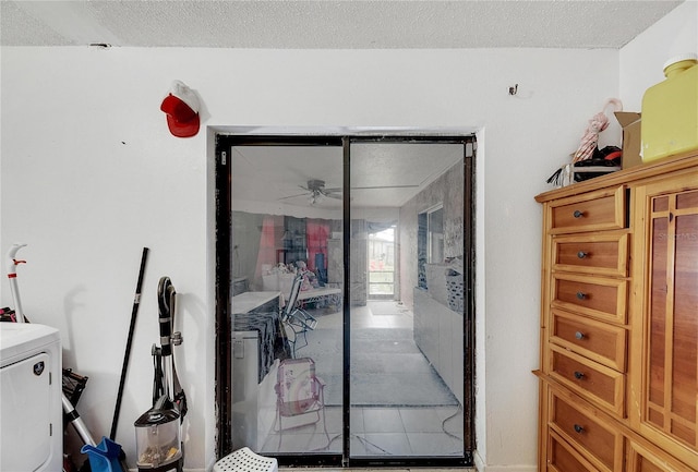 interior space featuring a textured ceiling, washer / clothes dryer, and a closet