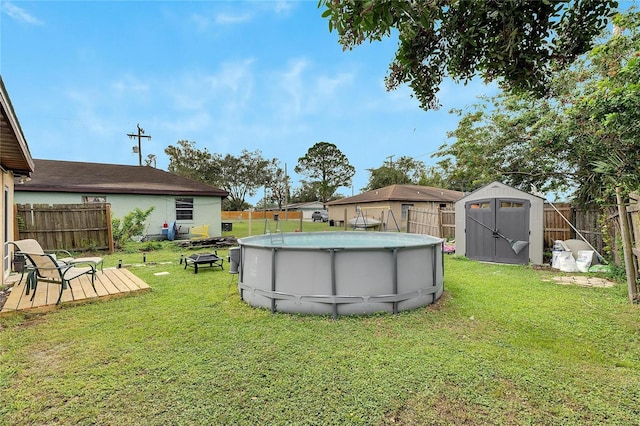 view of yard featuring a fenced in pool and a shed