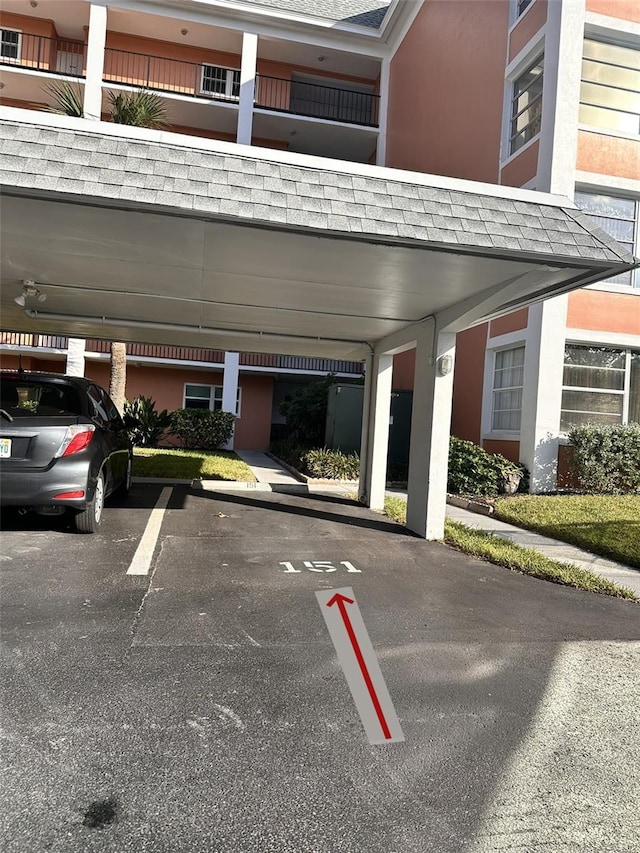 view of vehicle parking with a carport