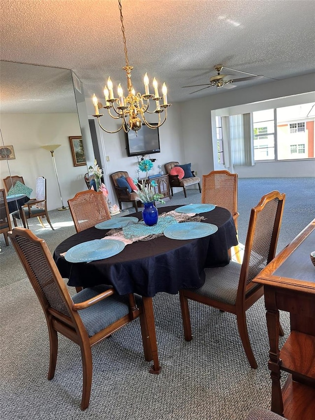 carpeted dining area with ceiling fan with notable chandelier and a textured ceiling