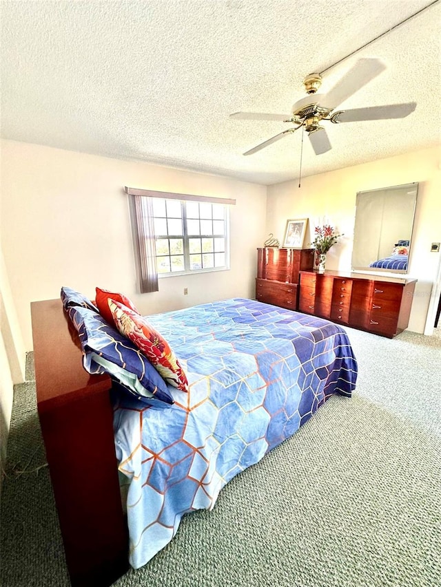 carpeted bedroom with a textured ceiling and ceiling fan