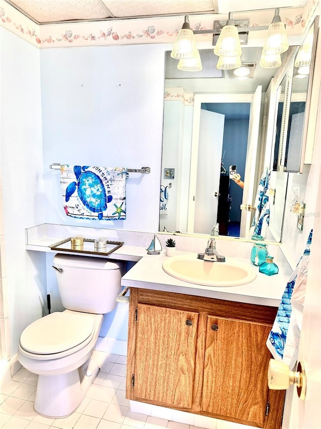 bathroom featuring tile patterned floors, vanity, and toilet