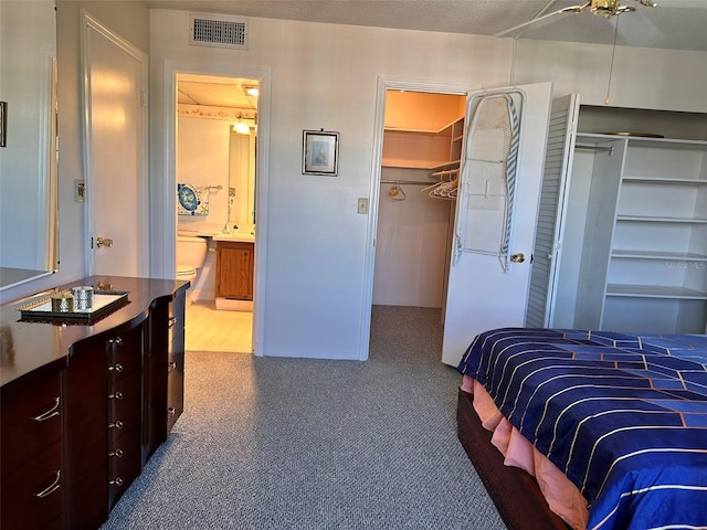 bedroom with connected bathroom and ceiling fan