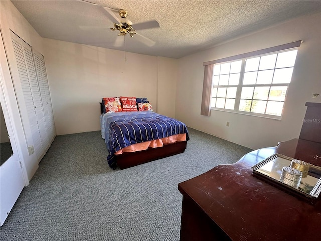 carpeted bedroom featuring ceiling fan, a textured ceiling, and a closet