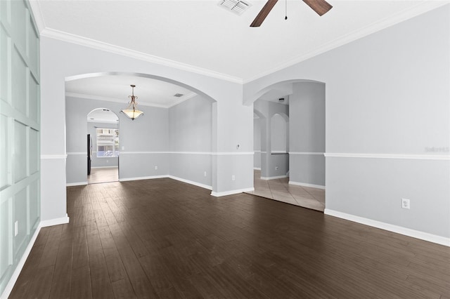 unfurnished room featuring hardwood / wood-style flooring, ceiling fan, and crown molding