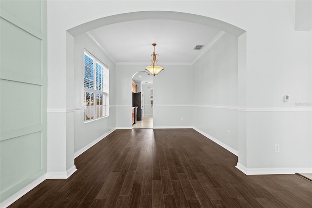 unfurnished dining area featuring ornamental molding and dark wood-type flooring