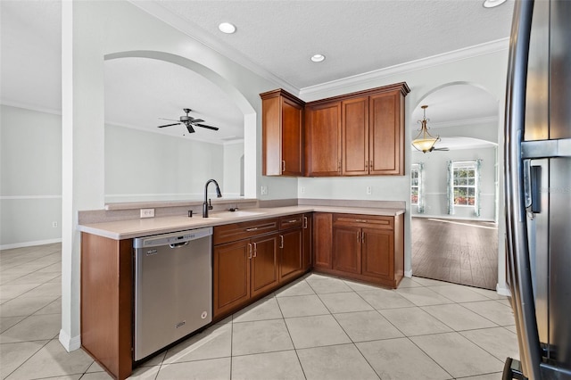 kitchen with sink, ceiling fan, ornamental molding, light tile patterned floors, and stainless steel appliances