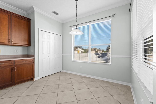 unfurnished dining area with light tile patterned floors and crown molding