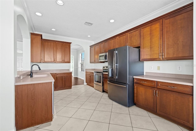 kitchen featuring sink, stainless steel appliances, crown molding, a textured ceiling, and light tile patterned flooring