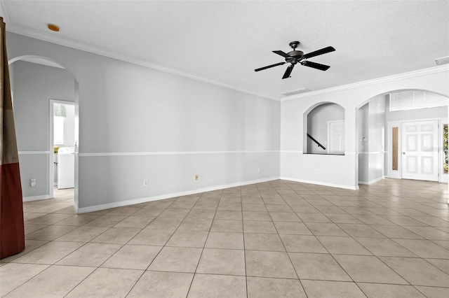 unfurnished room with a textured ceiling, washer / clothes dryer, ceiling fan, and crown molding