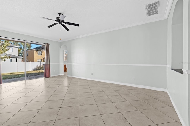 tiled empty room with ceiling fan, a textured ceiling, and ornamental molding