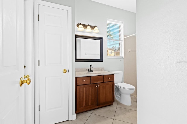 bathroom with tile patterned flooring, vanity, and toilet