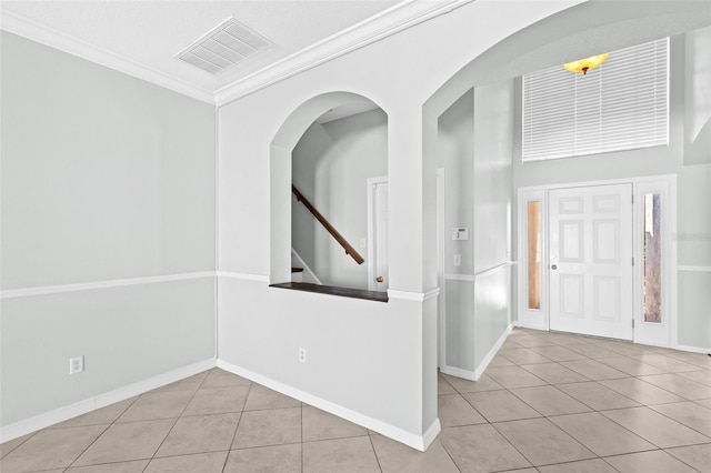 entrance foyer with light tile patterned floors and ornamental molding