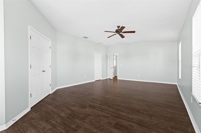 spare room featuring ceiling fan, dark hardwood / wood-style flooring, and lofted ceiling