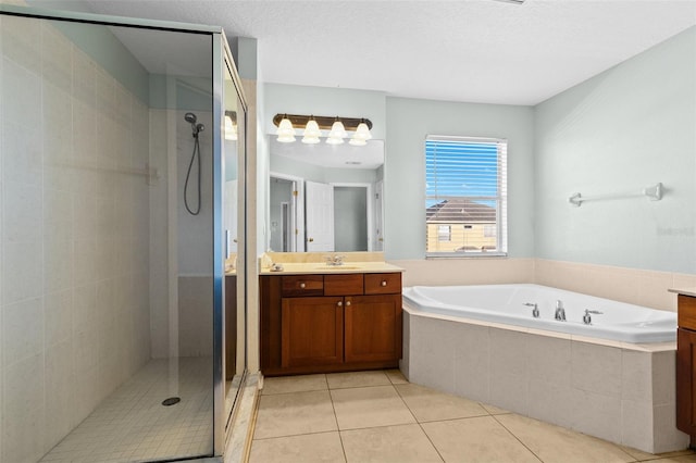 bathroom featuring tile patterned flooring, a textured ceiling, vanity, and plus walk in shower