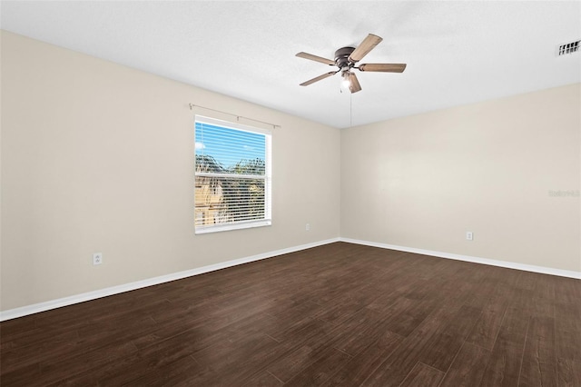 empty room with ceiling fan and dark wood-type flooring