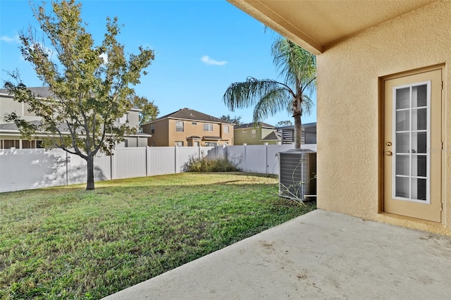 view of yard featuring central AC unit and a patio area