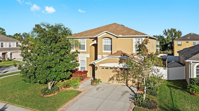 view of front of property featuring a front yard and a garage