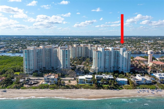 bird's eye view with a water view and a beach view